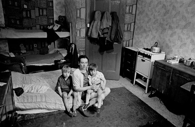 Mother living with her children in an overcrowded single end tenement flat. Glasgow, 1971.