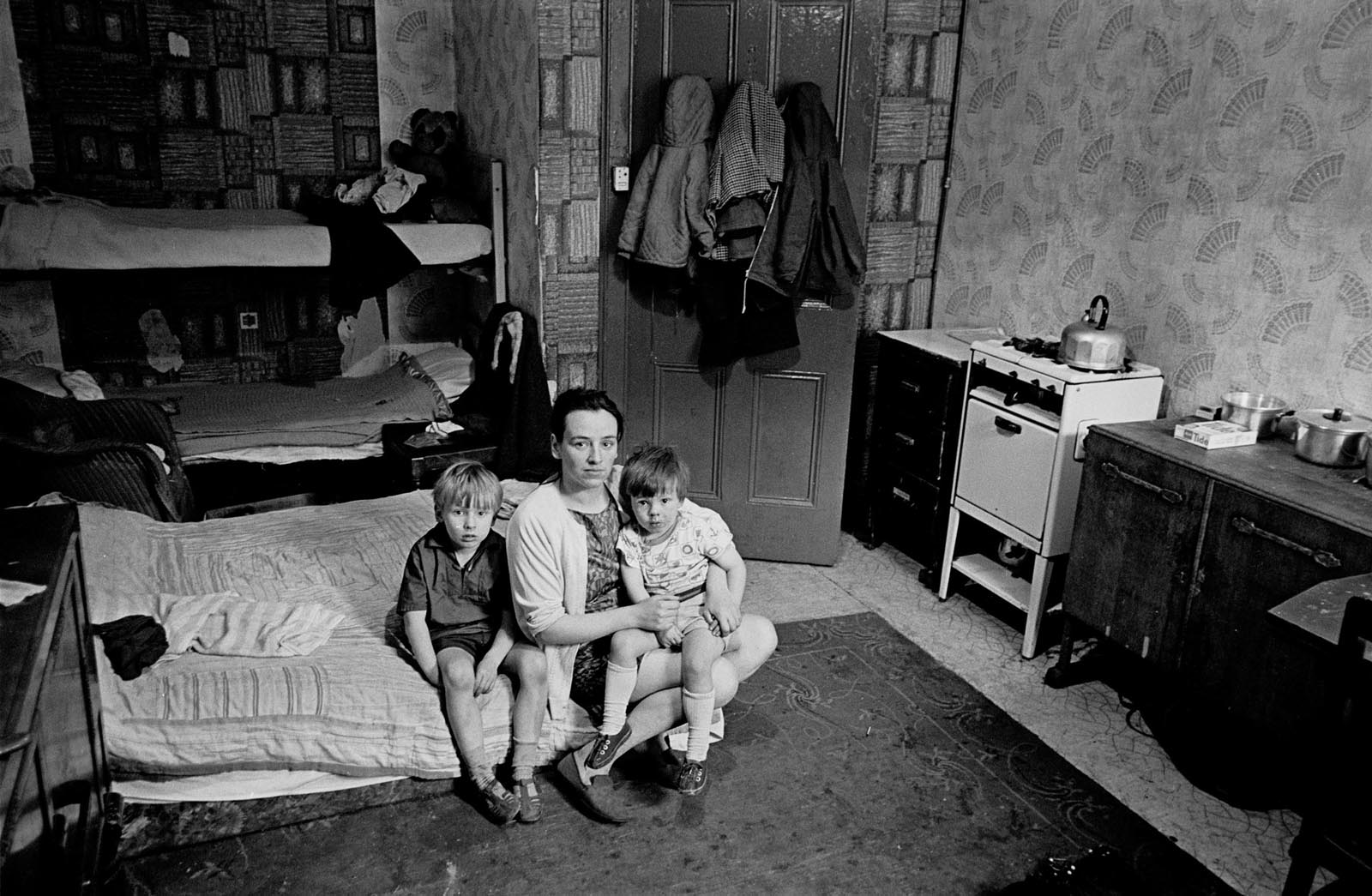 Mother living with her children in an overcrowded single end tenement flat. Glasgow, 1971.