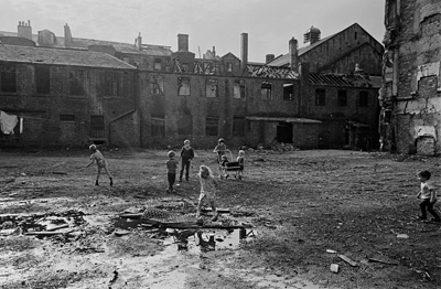 Children playing in a Gorbals tenement courtyard derelict site. Glasgow, 1970.